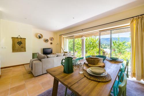 a living room with a table and a couch at Casa de Campo - Olive House in Areias de Vilar