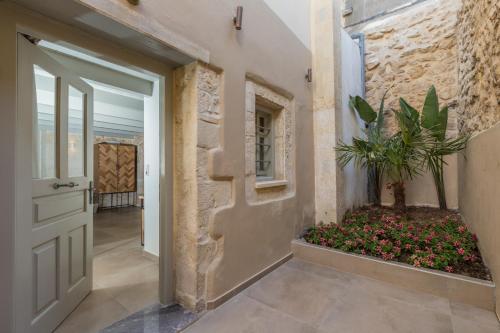 a hallway of a house with a door and a plant at Casa Vitae Villas in Rethymno