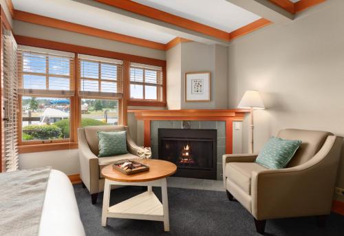 a living room with two chairs and a fireplace at La Conner Channel Lodge in La Conner
