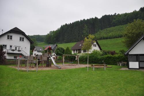 a park with a playground with a slide at Hotel Tiefenhagen Sauerland in Lennestadt