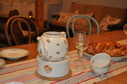 a table with a tea pot and a plate of bread at Horská chalupa U Hančilů in Pec pod Sněžkou