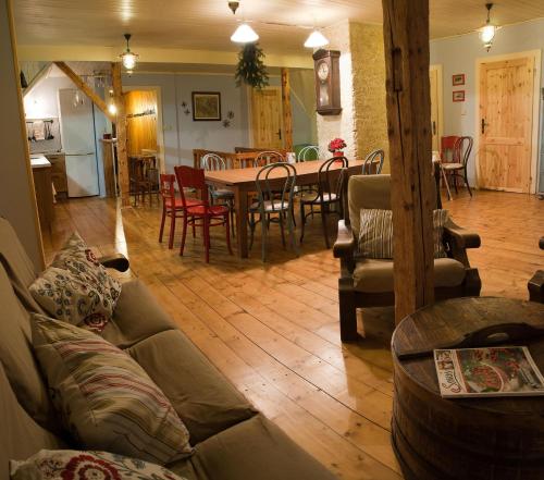 a living room with a couch and a table and chairs at Horská chalupa U Hančilů in Pec pod Sněžkou