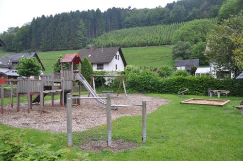 a park with a playground with a slide at Hotel Tiefenhagen Sauerland in Lennestadt