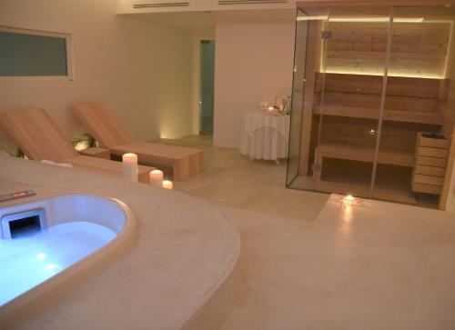 a large bathroom with a tub and a glass shower at Dimora TerraNostra&Spa in Ugento