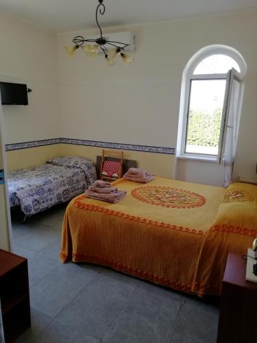 a bedroom with a large bed and a window at casadolcecasalatina in Latina