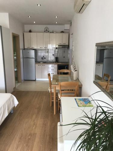a kitchen and dining room with a table and chairs at Apartments Jani in Hvar