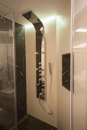 a bathroom with a shower and a mirror at Hedoné Design Experience B&B in Agrigento
