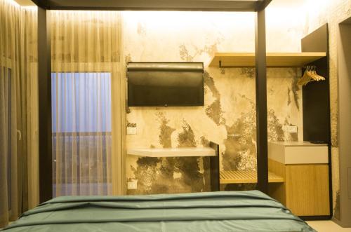 a room with a bed and a wall with mold at Hedoné Design Experience B&B in Agrigento