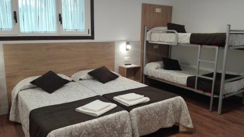 a bedroom with two beds and a bunk bed at Albergue y Habitaciones Privadas Boente in Boente