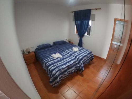 a bedroom with a bed with two towels on it at Paradise apartament in Gran Tarajal