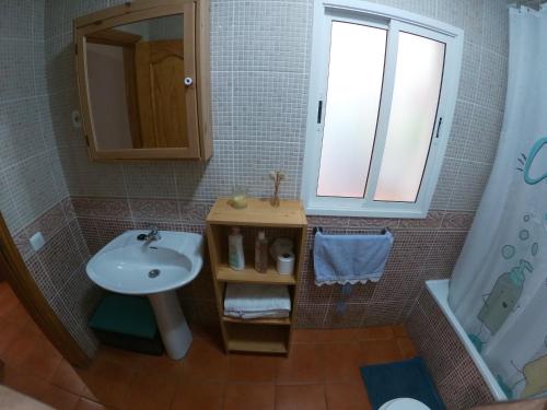 a small bathroom with a sink and a mirror at Paradise apartament in Gran Tarajal
