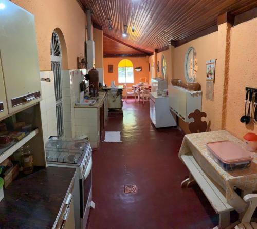 a large kitchen with a bunch of appliances in it at Casa na serra com cachoeira in Bom Jardim