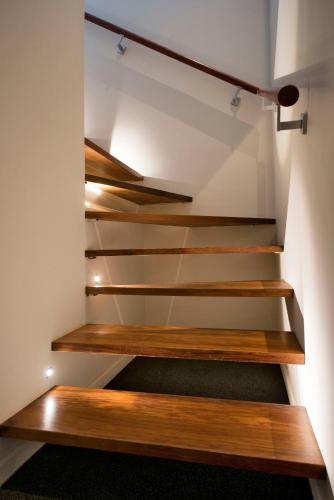 a stairwell in a house with wooden steps at Selah Retreat in Nelson