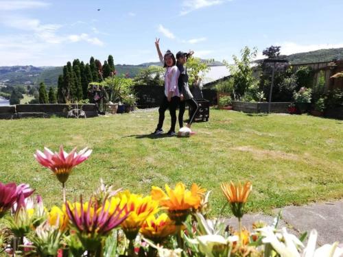 two girls playing with a soccer ball in a garden at rooms with a view in Haywards
