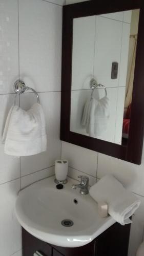 a bathroom with a white sink and a mirror at Cabañas Stommeln in Ovalle