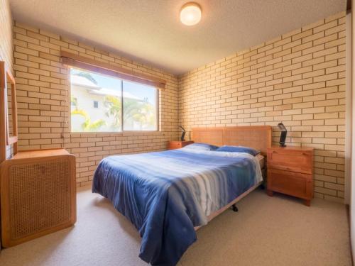 a bedroom with a bed and a window at Golden Shores Unit 3 21 Landsborough Parade in Caloundra