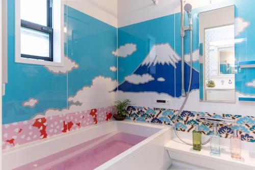 a bathroom with a tub with a mountain mural on the wall at CuteFamilyHouse! 8min Shinjuku 5minJR 3minSubway Cozy,Quiet KidsFree Under6yrs in Tokyo
