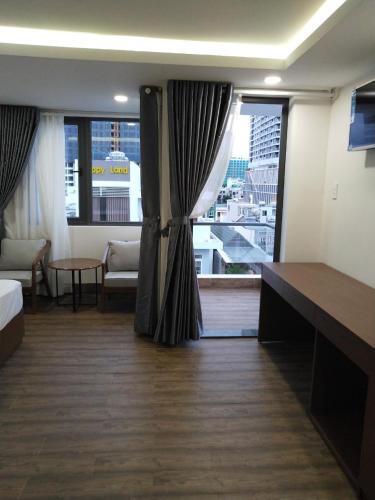 a hotel room with a bed and a large window at DORADO HOTEL in Nha Trang
