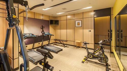 a gym with two treadmills and two exercise bikes at Atour Hotel (Changyang North Road) in Xiangyang