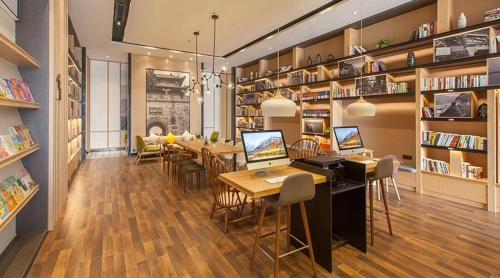 a room with a library with a table and chairs at Atour Hotel (Changyang North Road) in Xiangyang