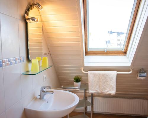 a bathroom with a sink and a window at Strandhaus Nr. 9 OG re. in Dahme
