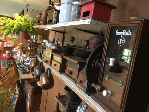 a kitchen with lots of pots and pans on a shelf at The Green land (Khok Kruat) in Nakhon Ratchasima