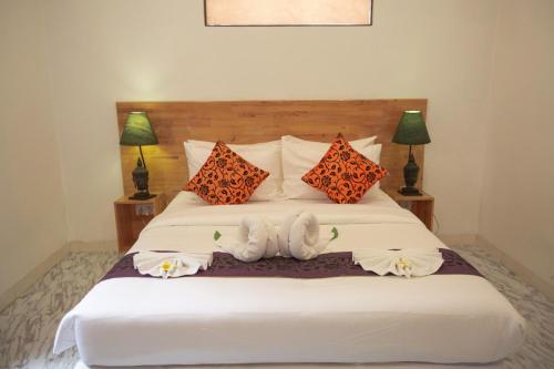 a bedroom with a bed with two towels on it at Bamboo9 Boutique in Phnom Penh