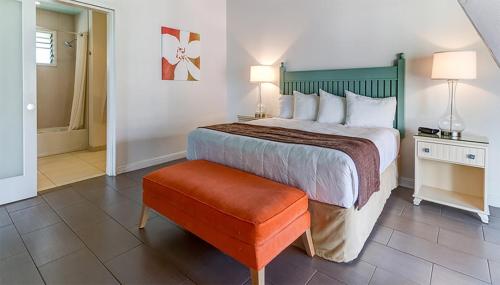 a hotel room with a bed and a stool at The ISO by Castle in Kapaa