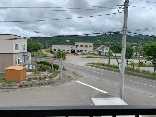 an empty street in a small town with houses at STAY Sakura in Bibai