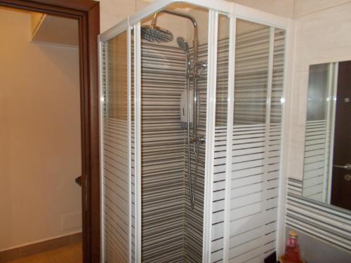 a shower in a bathroom with white blinds at Milla's house rome in Rome