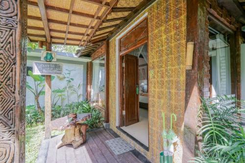 an entrance to a house with a wooden porch at KTS Balinese Villas in Canggu