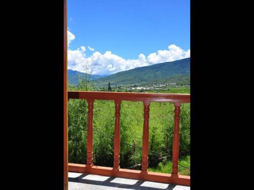 a view of a balcony with a view of the mountains at Nirvana Lodge in Paro