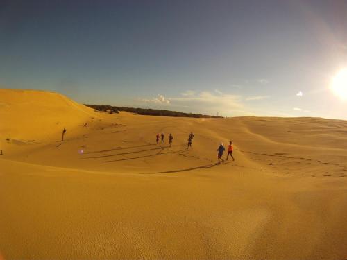 a group of people walking in the desert at Broughton Views in Corlette