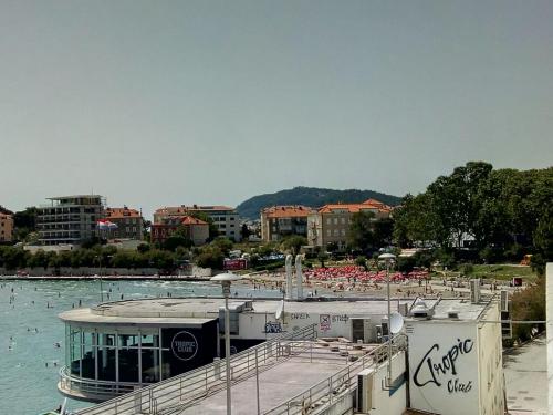a boat is docked in a body of water at Sunshower apartment and studio in Split