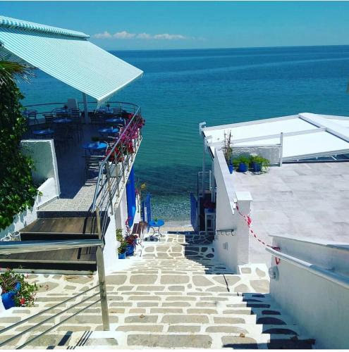a stairway leading down to the ocean from a building at Olympos Beach in Plaka Litochorou