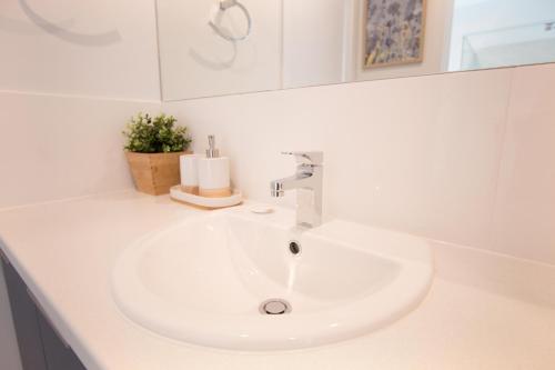 a white sink in a bathroom with a mirror at Contemporary ‘Esprit’ with river reserve access in Tailem Bend