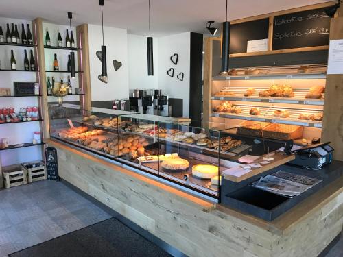 a bakery with a display case filled with lots of pastries at Kallido in Hermeskeil