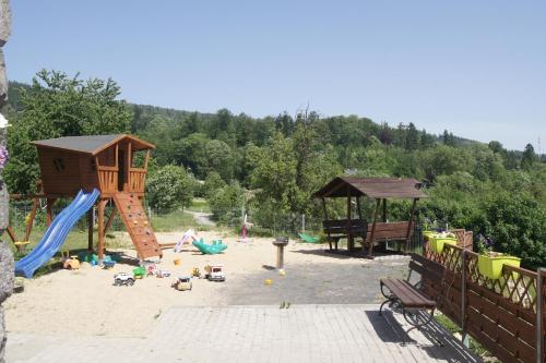 a playground with a slide and a play structure at Trzy Szczęścia in Szklarska Poręba