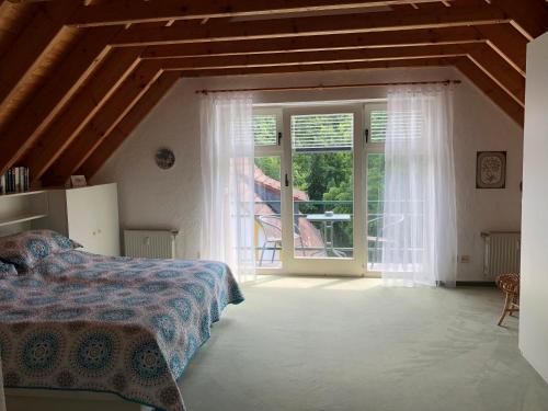 a bedroom with a bed and a large window at Ferienhaus "Alte Mühle" in Wiehl