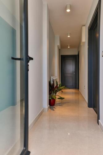 an empty hallway with a door and a plant at Hotel M in Podgorica