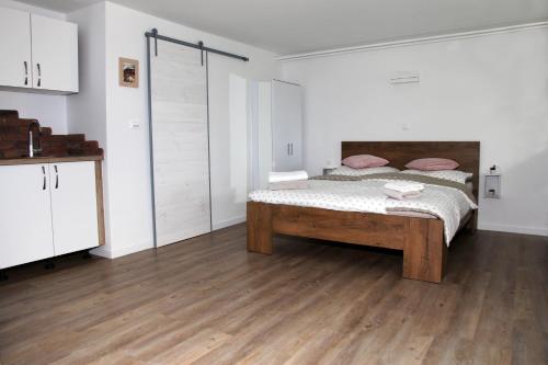 a bedroom with a bed and a wooden floor at STUDIO LUNA in Bled