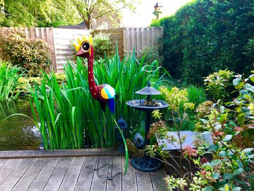 a colorful statue of a bird in a garden at Au chalet d'Isa in Havelange