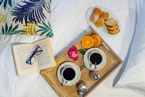 a tray with two cups of coffee and a plate of food at Diamante Beachfront Suites in Xylokastron