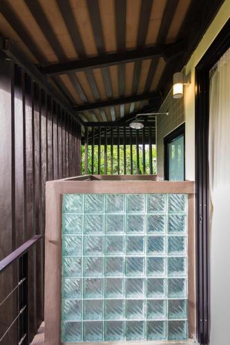 a glass door in a room with a ceiling at The River Resort in Champasak