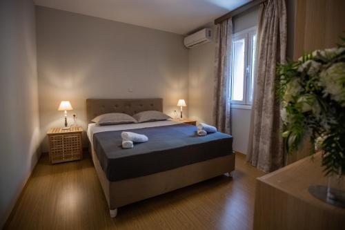 a bedroom with a bed with two pillows and a window at THALASSA VIEW RESIDENCE in Argostoli