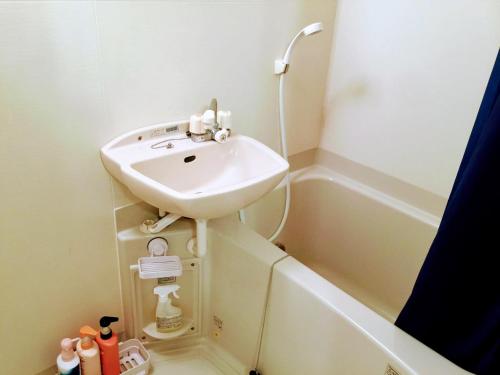 a bathroom with a sink and a bath tub at Yoron Tandy-House in Yoron