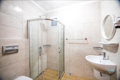 a bathroom with a shower and a toilet and a sink at Private Hotel in Marmaris