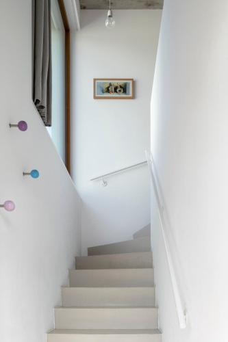 a staircase in a house with white walls at Cologne Country Lodge in Cologne