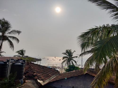 a view of the beach from a resort with palm trees at RJ14 Accommodations at Baga Beach in Baga