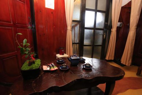 a table with dishes on it in a room at Crazy House in Da Lat